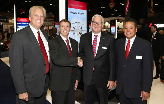 (L to R) Warren Kroeppel, Sheltair, COO; Frank Seymour, Sheltair, SVP; Joe Moeggenberg, ARGUS, CEO; Tom Craft, Sheltair, SVP of FBO Operations. Joe Moeggenberg congratulates Sheltair’s executive team at NBAA-BACE.