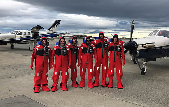 The TBMs crew in survival suits before their departure from Chilean Antárctica airport | photo S. Diaz.