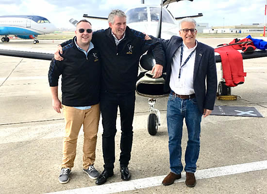 Daher CEO Didier Kayat (at right) welcomes Dierk Reuter (center) and Phil Bozek at Le Bourget Airport following the two pilots’ record-setting transatlantic flight from New York to Paris.