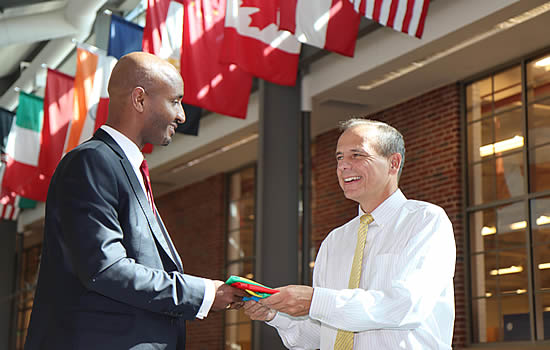 Dawit Lemma presents the Ethiopian flag to Tom Frooninckx, Interim Head of the School of Aviation and Transportation Technology (SATT) at Purdue University.