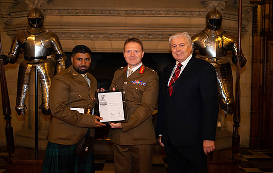 Loganair First Officer and Army Reservist Private, Aakash Sajid with Maurice Boyle, Loganair Chief Operations Officer as they receive the Silver ERS Award from Major General Bill Wright CBE