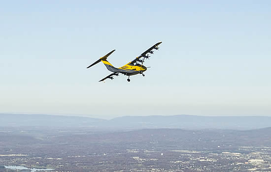 Electra's EL-2 Goldfinch soars over the Virginia countryside with a small turbogenerator and batteries powering its eight electric propellers. (Credit: JP Stewart/Electra).